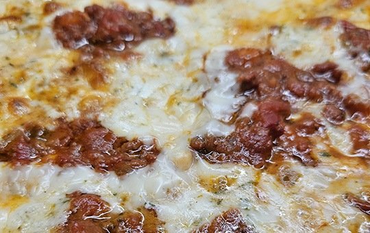 BBQ Chicken Bandit Pizza with mesquite grilled chicken, bacon, red onion and BBQ sauce - Monte Bello Pizzeria