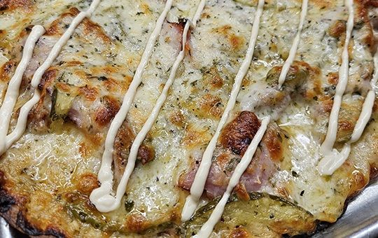 Close-up of the Cubano Bello specialty pizza, September pizza of the month at Monte Bello Pizzeria